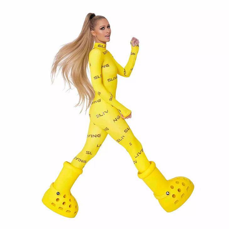 Paris Hilton Models MSCHF x Crocs Big Yellow Boots